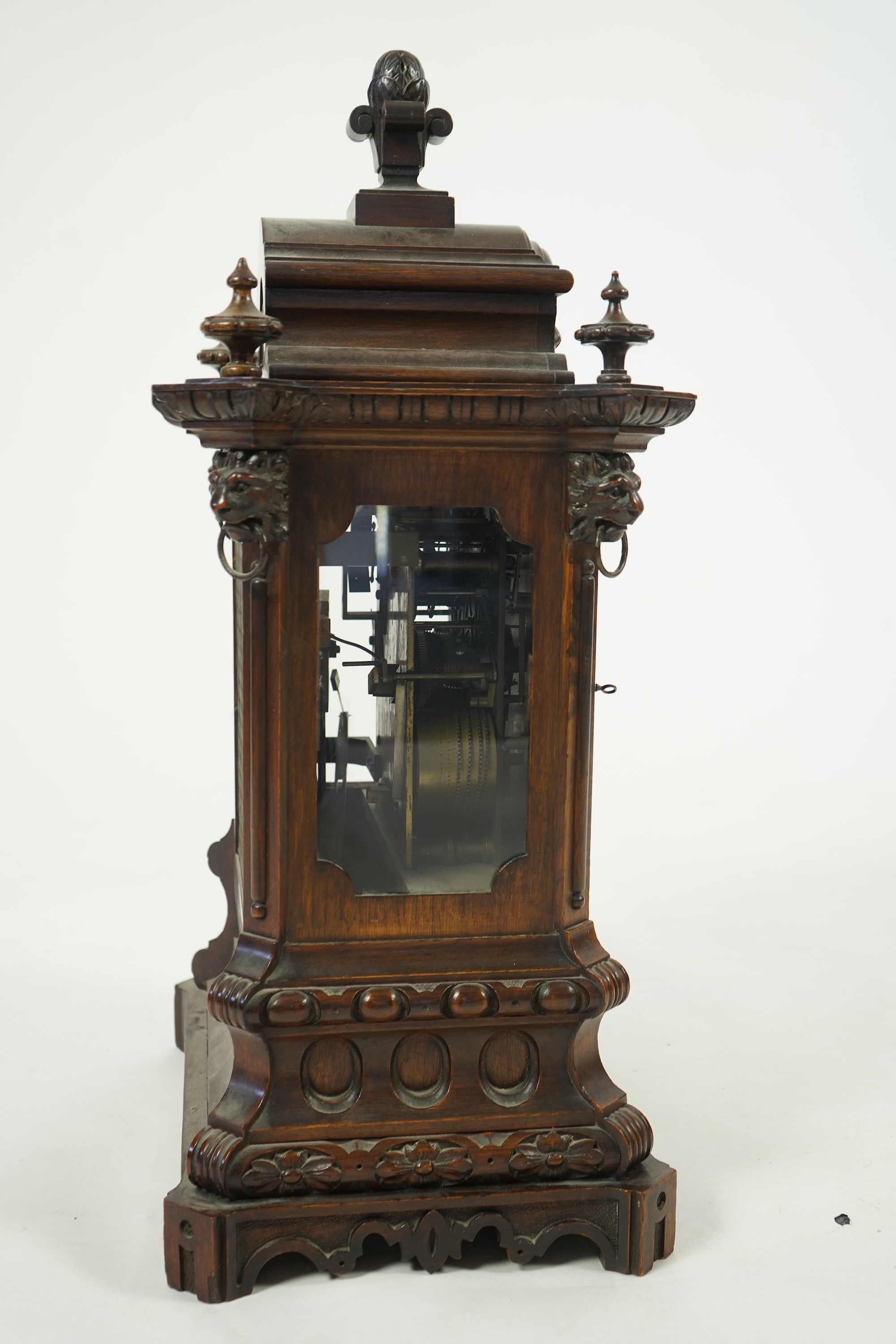 A late 19th century carved oak triple fusee bracket clock